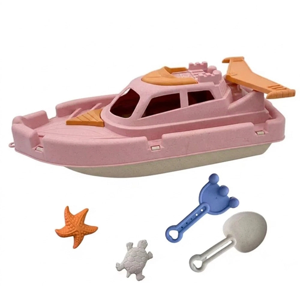 Bateau de plage rose avec moules marins et accessoires